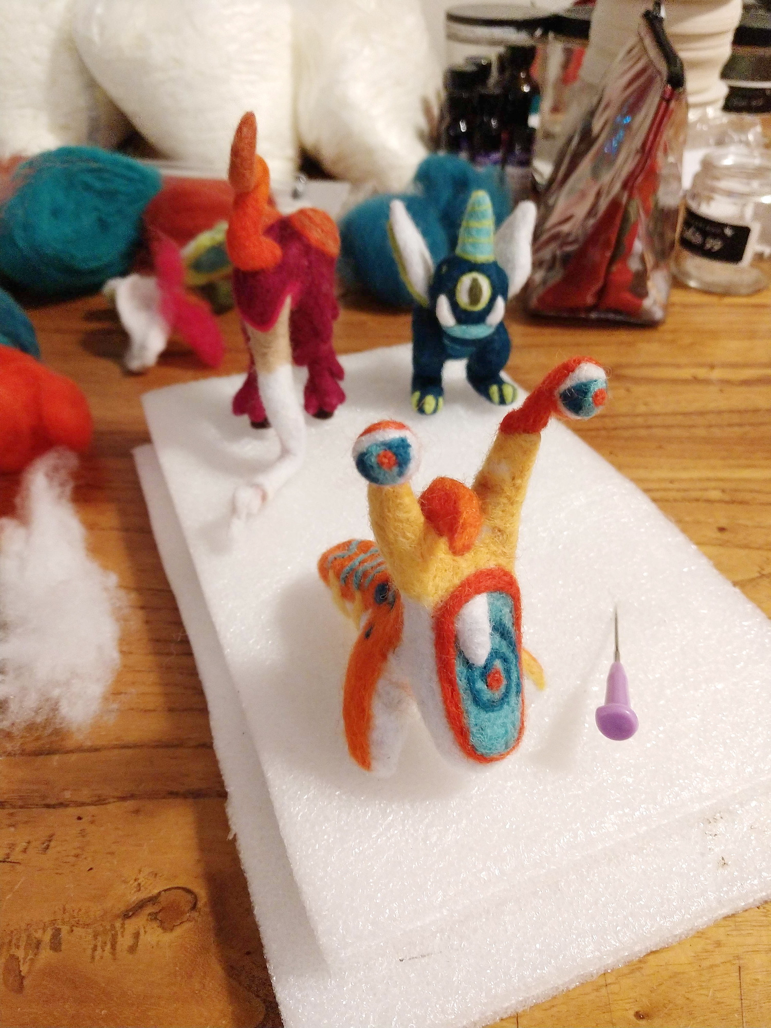 Cute Handmade Felt Monster Ornaments in the process of being created by hand, one poke at a time.